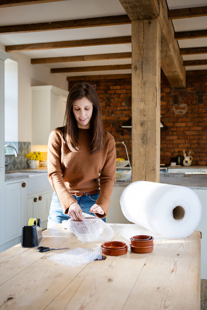 Rebecca helping to bubblewrap kitchen items.